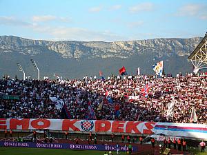 Torcida fans waving flags as we cheer on Hajduk.