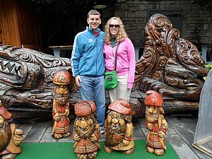 Kevin and Kyleen in front of some fun wood sculptures of the seven dwarves