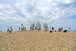 Punta del Esta - sculpture of fingers extending out of the sand.