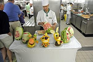 On the ship, taking a galley tour - a fruit carver displaying his amazing work.