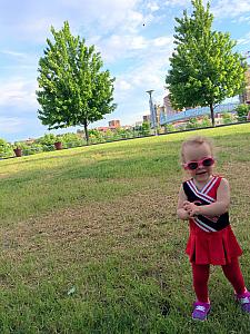 Dressed up in Reds cheerleader outfit as Dad goes to the Reds game. Playing at Christian Moerlein's back lawn.