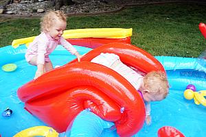 Capri and Kenley playing on the pool slide