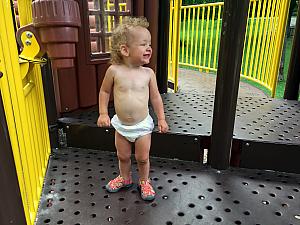 Capri was struggling to climb on the playground in her frilly dress - and didn't like the idea of wearing the backup onesie instead - so, she played on the playground in her diaper :)