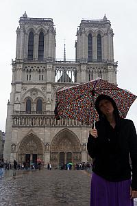 Kelly showing off our feelings about the rain in front of the Notre Dame Cathedral.