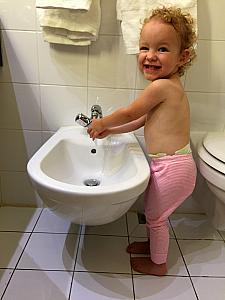 Capri is super excited to use her own personal sink -- the bidet! Also, this was at about 11pm, 2-3 hours past her normal bedtime!