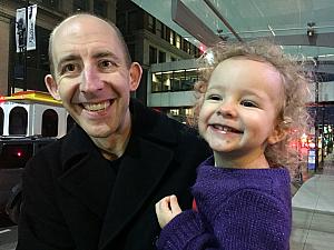 All smiles with daddy waiting for the "train" (the streetcar)