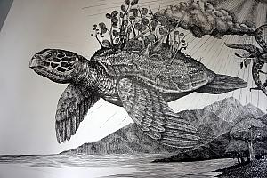 A close up of a turtle in a beautiful mural at the museum entrance.