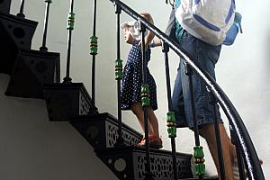Capri and Dad climbing a spiral staircase, inside a lighthouse.
