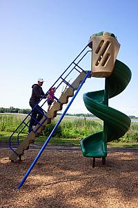 Uncle Jay taking Kenley up the big twisty slide