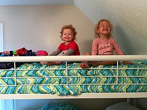 Capri and Kenley having fun on the top bunk of the bunk bed. 