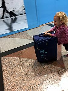 She loved running through the airport pushing her suitcase the whole way.
