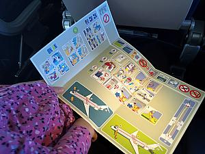The airplane safety instruction card served as Capri's naptime reading. Ha!